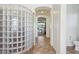 Hallway with arched ceiling, glass block wall, and tile floors at 18329 W Montebello Ave, Litchfield Park, AZ 85340