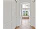 Hallway view leading to bathroom with tile floors and white walls and an arched ceiling at 18329 W Montebello Ave, Litchfield Park, AZ 85340