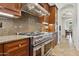 A kitchen showcases stainless steel oven, custom cabinets, and granite countertops, blending style with functionality at 18329 W Montebello Ave, Litchfield Park, AZ 85340