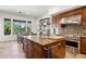 The kitchen is equipped with stainless steel appliances and a large island with a granite counter top at 18329 W Montebello Ave, Litchfield Park, AZ 85340