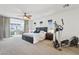 Bright, spacious main bedroom suite with a king bed, exercise equipment and an office space at 18329 W Montebello Ave, Litchfield Park, AZ 85340