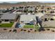 Expansive aerial view of a desert home with well-maintained landscaping, backyard patio, and mountain views at 18493 W Hiddenview Dr, Goodyear, AZ 85338