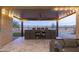 Covered outdoor living area features a built-in grill and scenic desert views at 18493 W Hiddenview Dr, Goodyear, AZ 85338
