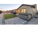 Landscaped backyard featuring a relaxing hot tub and custom paver patio, perfect for outdoor enjoyment at 18493 W Hiddenview Dr, Goodyear, AZ 85338