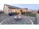 Inviting backyard with a cozy fire pit, outdoor kitchen, and a relaxing covered patio area for entertaining at 18493 W Hiddenview Dr, Goodyear, AZ 85338