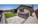 Backyard featuring artificial turf, brick pavers, and a spa with a view of the surrounding desert landscape at 18493 W Hiddenview Dr, Goodyear, AZ 85338