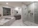 Beautiful bathroom featuring granite counters, large soaking tub, and stylish glass shower at 18493 W Hiddenview Dr, Goodyear, AZ 85338