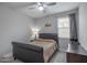 Cozy bedroom with a ceiling fan, upholstered headboard, and lots of natural light at 18493 W Hiddenview Dr, Goodyear, AZ 85338