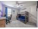 Fun bedroom with gaming decor, a bunk bed, and an office desk at 18493 W Hiddenview Dr, Goodyear, AZ 85338
