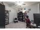 Cozy bedroom features a ceiling fan, carpet flooring, and built-in shelving at 18493 W Hiddenview Dr, Goodyear, AZ 85338