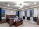 Comfortable bedroom with ceiling fan, plush carpeting, and plenty of natural light at 18493 W Hiddenview Dr, Goodyear, AZ 85338