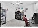 Office or bedroom with a ceiling fan, a desk, and black shelving and decor at 18493 W Hiddenview Dr, Goodyear, AZ 85338