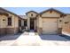 Welcoming front entrance with seating area and manicured landscaping, providing a cozy and inviting curb appeal at 18493 W Hiddenview Dr, Goodyear, AZ 85338