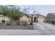 Charming single-story home with a well-manicured lawn and a two-car garage at 18493 W Hiddenview Dr, Goodyear, AZ 85338