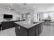 Open-concept kitchen with large island, stainless steel faucet, and eating area nearby at 18493 W Hiddenview Dr, Goodyear, AZ 85338