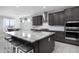 Kitchen featuring a center island with stools, stainless steel appliances, and ample storage at 18493 W Hiddenview Dr, Goodyear, AZ 85338