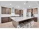 Modern kitchen featuring stainless steel appliances, a large granite island, and ample cabinet space for storage at 18493 W Hiddenview Dr, Goodyear, AZ 85338