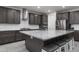Kitchen with island, granite countertops, stainless steel appliances, and dark cabinets at 18493 W Hiddenview Dr, Goodyear, AZ 85338