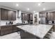 Gorgeous kitchen with granite countertops, dark cabinets, and stainless steel appliances at 18493 W Hiddenview Dr, Goodyear, AZ 85338