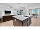Open kitchen with a large island, seating, and views of the living area and dining space, ideal for modern living at 18493 W Hiddenview Dr, Goodyear, AZ 85338