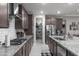 Modern kitchen design with spacious island, dark wood cabinets, and pantry at 18493 W Hiddenview Dr, Goodyear, AZ 85338