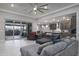 Spacious living room featuring a large ceiling fan and sliding glass doors to the patio at 18493 W Hiddenview Dr, Goodyear, AZ 85338