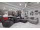 Open-concept living room flowing into the kitchen with modern gray finishes at 18493 W Hiddenview Dr, Goodyear, AZ 85338