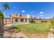 Expansive backyard featuring a well-manicured lawn, a shed, and a covered patio at 19 W Wickieup Ln, Phoenix, AZ 85027