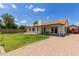 Large backyard with a well-manicured lawn, patio area, and a boat parked in the driveway at 19 W Wickieup Ln, Phoenix, AZ 85027