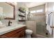 Beautifully updated bathroom featuring a tiled shower with a glass enclosure and floating shelves at 19 W Wickieup Ln, Phoenix, AZ 85027