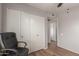 Bedroom with wood-look floors and a closet with double doors at 19 W Wickieup Ln, Phoenix, AZ 85027