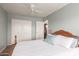 Comfortable bedroom with wood-look flooring, and a closet with double doors at 19 W Wickieup Ln, Phoenix, AZ 85027