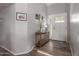 Inviting entryway with wood floors, a decorative table, and a charming front door with glass panels at 19 W Wickieup Ln, Phoenix, AZ 85027