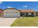 Charming single-story home with a two-car garage, well-maintained lawn, and lovely curb appeal on a sunny day at 19 W Wickieup Ln, Phoenix, AZ 85027