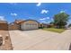 Charming single-story home with a two-car garage, well-maintained lawn, and a large driveway on a sunny day at 19 W Wickieup Ln, Phoenix, AZ 85027