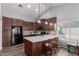 Well-lit kitchen with stainless steel appliances, a large island with seating, and attractive pendant lighting at 19 W Wickieup Ln, Phoenix, AZ 85027