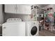 Bright laundry room with ample shelving and storage space, plus a washer and dryer at 19 W Wickieup Ln, Phoenix, AZ 85027