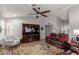 Spacious living room with a ceiling fan, wood-look tile flooring, and a large media center at 19 W Wickieup Ln, Phoenix, AZ 85027