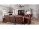 Large living room with a fireplace, wood-look floors, comfortable seating, and a ceiling fan at 19 W Wickieup Ln, Phoenix, AZ 85027
