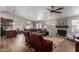 Spacious living room with a fireplace, wood floors, modern furniture, and an open layout to the dining area at 19 W Wickieup Ln, Phoenix, AZ 85027