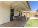 Covered patio area perfect for outdoor dining and relaxing, adjacent to a lush lawn at 19 W Wickieup Ln, Phoenix, AZ 85027