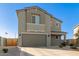 Two-story home showcasing a neutral stucco facade, attached garage, and xeriscaping in a sunny setting at 22962 N 182Nd Ln, Surprise, AZ 85387