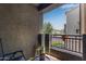 Balcony area with chair and plant, with a view of nearby buildings and green space at 2401 E Rio Salado Pkwy # 1192, Tempe, AZ 85288