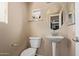 Powder bathroom featuring a pedestal sink, decorative mirror, and neutral color palette at 2401 E Rio Salado Pkwy # 1192, Tempe, AZ 85288
