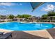 Community pool surrounded by lounge chairs and lush landscaping and gazebos at 2401 E Rio Salado Pkwy # 1192, Tempe, AZ 85288