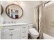 Bathroom featuring a vanity with marble countertop, round mirror, and decorative shower curtain at 241 W Roadrunner Dr, Chandler, AZ 85286