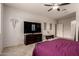 This bedroom features a ceiling fan, neutral tones, and a large TV on a wood dresser at 241 W Roadrunner Dr, Chandler, AZ 85286