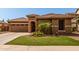 Inviting home exterior features a stone accent entry, three car garage, and manicured landscaping at 241 W Roadrunner Dr, Chandler, AZ 85286