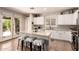 Bright kitchen features white cabinets, a center island with seating, and stainless steel appliances at 241 W Roadrunner Dr, Chandler, AZ 85286