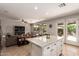 Open concept kitchen with a center island flowing seamlessly into the living room and outdoor patio at 241 W Roadrunner Dr, Chandler, AZ 85286